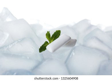 Chewing Gums And Mint On Ice Cubes Against White Background, Closeup