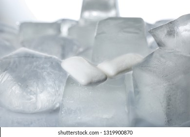 Chewing Gums On Ice Cubes Against White Background, Closeup