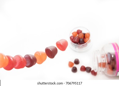 Chewy Gummy Multivitamins In A Bowl And A Spilled Bottle