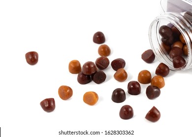 Chewy Gummy Multivitamins In A Spilled Bottle With White Background