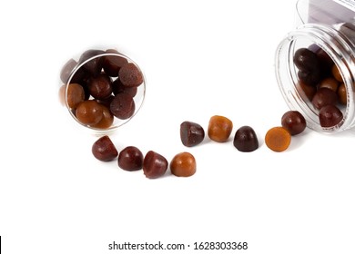 Chewy Gummy Multivitamins In A Spilled Bottle With White Background