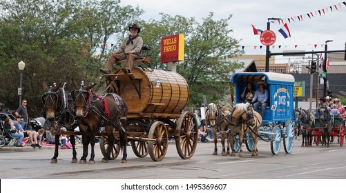 Cheyenne, Wyoming - July 27, 2019: Several Wagon And Carriage Entries In A Cheyenne Frontier Days Parade. One Wagon Driven From Atop, Likely Carried Liquid Due To Its Wooden Barrel-like Construction.