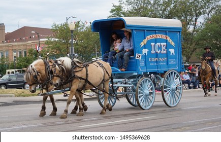 Cheyenne, Wyoming - July 27, 2019: A Blue Wagon From The Lakeview Ice Company Is On Display In A Cheyenne Frontier Days Parade. Before Refrigeration, Wagons Like This Would Haul Ice In The Region.