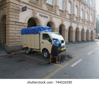 Chhatrapati Shivaji Terminus Area, Fort, Mumbai, Maharashtra, India - October 25, 2017 - A Young Man/ Driver Is Seen Busy Cleaning His Tempo/ Truck Early In The Morning.