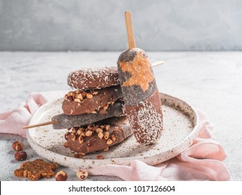 Chia popsicle with raw carrot cake and chocolate on gray background. Healthy recipe and idea homemade vegan popsicle ice cream. Easter dessert idea. Copy space for text