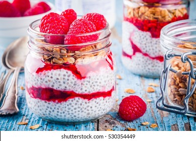 chia pudding with raspberry sauce, granola and fresh raspberries on rusic background - Powered by Shutterstock