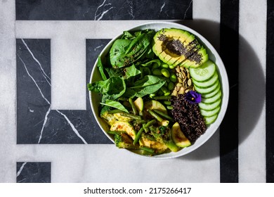 Chia Salad With Tomatoes, Broccoli, Basil, Broccoli, Zucchini, Cucumber, Asparagus Beans, Sesame Seeds, Watermelon Seeds, Avocado, Beans, Violet Flower In A Plate On A Background With A Letter