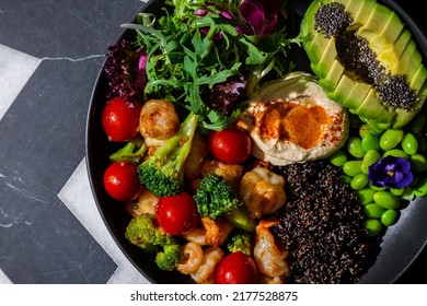 Chia Salad With Tomatoes, Shrimps, Broccoli, Arugula, Sesame Seeds, Endive, Mashed Potatoes, Avocado, Beans, Violet Flower In A Plate On A Background With A Letter