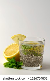 Chia Seeds Drink With Water In Glass With Lime Lemon Mint White Background