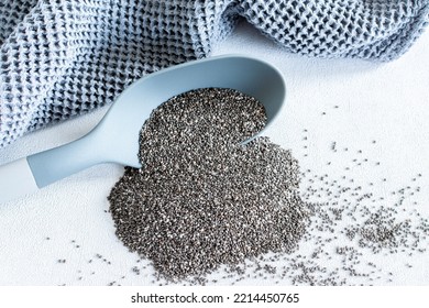 Chia Seeds Falling From A Gray Plastic Spoon