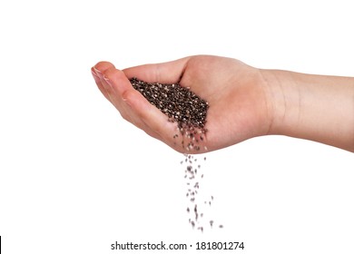 Chia Seeds Falling From Hand. Isolated Over White.