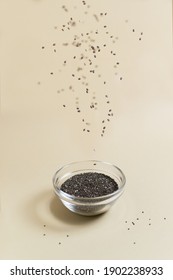 Chia Seeds With A Glass Bowl On A Yellow Background. Flying Food Concept. Superfood. Vertical Orientation.