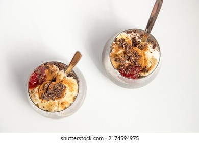 Chia Seeds From The Salvia Hispanica Plant. Glass Cup With Hydrated Seeds, Natural Yogurt, Banana, Strawberry Jam, Cinnamon Powder And Chocolate Shavings. Image Seen From Above On White Background.