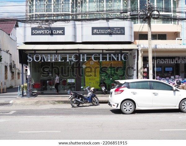 Chiang Mai,\
Thailand - 09,20,2022: Cosmetic surgery clinic with car and\
motorcycle parked on the street in\
front.