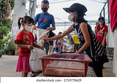 Chiang Mai, Thailand- 1 May 2020 : Corona Virus 2019 pandemic impacts people on unemployment and hunger.The young girl receive the free food with joy.