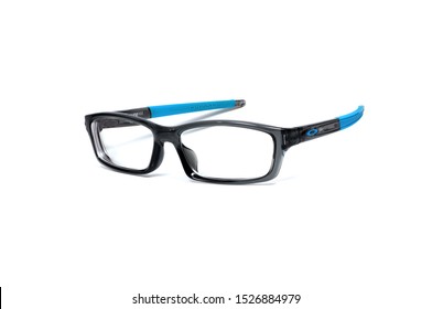 Chiang Mai, Thailand - 10 October 2019 : OAKLEY Closeup Blue Eyeglasses Placed on a white background
