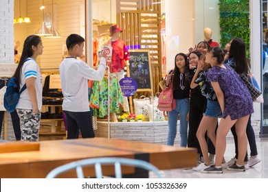 Chiang Mai, Thailand - 3 January 2018 - Group Of Thai Teenagers Act Out For Their Friend To Take Photo At A Shopping Mall In Chiang Mai, Thailand On January 3, 2018