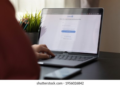 CHIANG MAI, THAILAND, APR 10, 2021 : A Woman Using Macbook Pro With LinkedIn On The Screen.LinkedIn Is A Photo-sharing Web