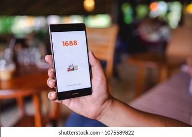 CHIANG MAI, THAILAND - April 17,2018: Man hands holding HUAWEI with 1688 apps on the screen.1688.com also called Alibaba.cn is the popular Chinese versions of Alibaba.com.