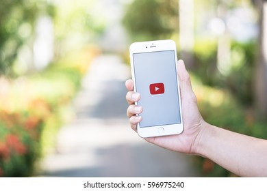 CHIANG MAI, THAILAND - Feb 12,2017: Hand Of Man Holding A Apple IPhone With You Tube App Showing On IPhone 6s. YouTube Is The Popular Online Video-sharing Website.