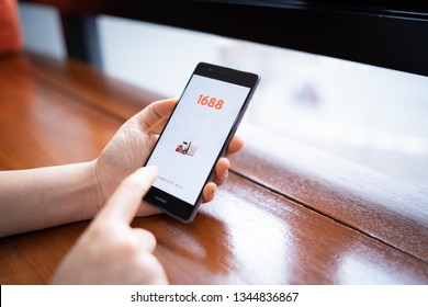 CHIANG MAI, THAILAND - FEB. 18,2019: Woman holding HUAWEI with 1688 apps on the screen.1688.com also called Alibaba.cn is the popular Chinese versions of Alibaba.com.