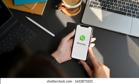 CHIANG MAI, THAILAND - FEBRUARY 1, 2020 : female using WhatsApp application on iPhone. WhatsApp is multi-function messaging application