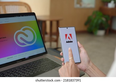 Chiang Mai Thailand. Jul 09, 2022.  Woman Holding Mobile Phone To Open Adobe Creative Cloud To Create Work, Photo, Video, Template, Pdf