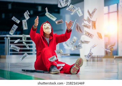 Chiang Mai, Thailand – July 23, 2022 : Person With Weapon And Red Costume With Iconic Dali Face Mask Tossing Money In The Air. The Series Money Heist, La Casa De Papel