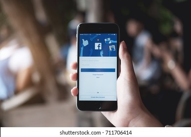 CHIANG MAI ,THAILAND - JULY 30, 2017 : Woman hand holding iPhone 6S to use facebook with new login screen.Facebook is a largest social network and most popular social networking site in the world.