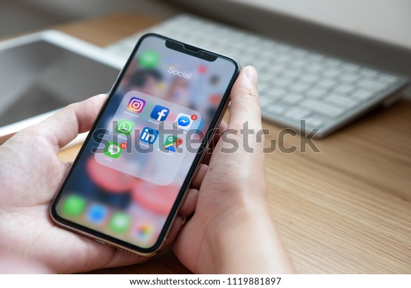 CHIANG MAI, THAILAND - JUN 22, 2018: Hand of man using iPhone X with icons of social media on screen, smartphone life style, smartphone era, smartphone in everyday life