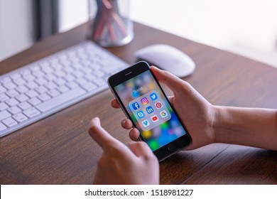 CHIANG MAI, THAILAND - June 30,2018: Woman holding Apple iPhone  with icons of social media on screen. Social media are most popular tool. Smartphone lifestyle. Starting social media app.