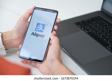 CHIANG MAI, THAILAND - Mar 08, 2020 : Woman holding Oneplus 6 with Alipay logo, Alipay is application from china.