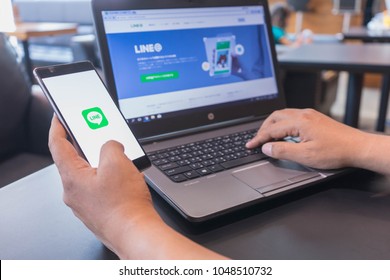 CHIANG MAI, THAILAND - Mar 18,2018: Man hands holding HUAWEI with LINE apps on screen. LINE is a new communication app which allows you to make free voice calls and send free messages.
