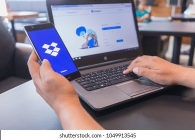 CHIANG MAI, THAILAND - Mar 18,2018: Man hands holding HUAWEI with Dropbox on the screen. Dropbox is a service that gives you access to images, documents and videos online from anywhere.