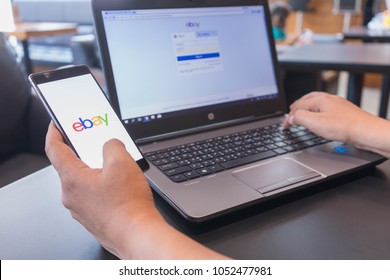 CHIANG MAI, THAILAND - Mar 18,2018: Man hands holding HUAWEI with eBay apps on the screen. eBay is one of the most popular ways to buy and sell goods and services on the internet.