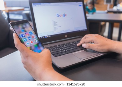 CHIANG MAI, THAILAND - Mar 18,2018: Man holding HUAWEI with icons of social media on screen. Social media are most popular tool.  Smartphone lifestyle. Starting social media app.
