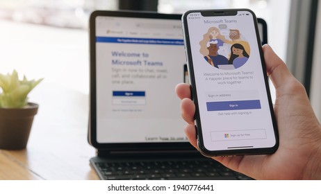 CHIANG MAI, THAILAND - MAR 21, 2021 : A working from home employee is downloading the Microsoft Teams social platform, ready for remote working in isolation from home