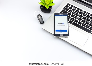 CHIANG MAI, THAILAND - MARCH 27 2016: Samsung Galaxy Alpha Showing linkedin application on the screen on the desk white space. Background
