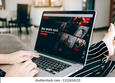 CHIANG MAI ,THAILAND - March 31, 2018 : Woman using computer laptop and watching Netflix website. Netflix being popular internationally.
