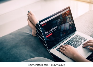 CHIANG MAI ,THAILAND - March 31, 2018 : Woman using computer laptop and watching Netflix website. Netflix being popular internationally.