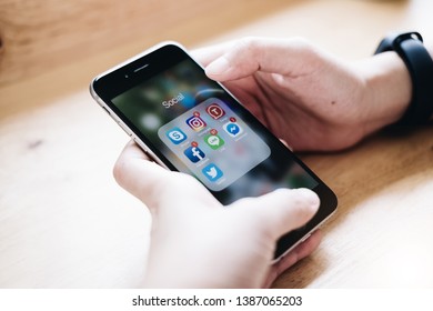 CHIANG MAI, THAILAND - MAY 01 ,2019: Woman holding Apple iPhone 6S with icons of social media on screen. Social media are most popular tool. Smartphone life style. Starting social media app.