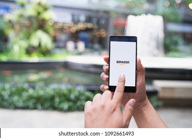 CHIANG MAI, THAILAND - May 05,2018: Man hands holding HUAWEI with Amazon apps. Amazon is an American international electronic commerce company. It's the world's largest online retailer. - Shutterstock ID 1092661493