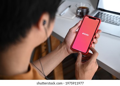 Chiang Mai, Thailand - May 13, 2021 : Man holding iPhone 11 Pro Max with tinder app. Tinder is a social search and dating mobile app.