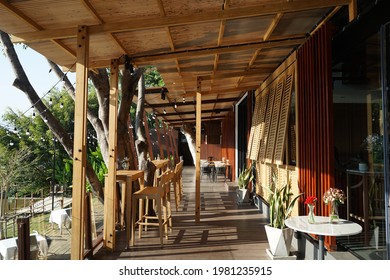 CHIANG MAI, THAILAND- MAY 27, 2021: Exterior architecture and building design at 'DECK ONE' local Thai and western restaurant decorated with wooden modern furniture by Ping river