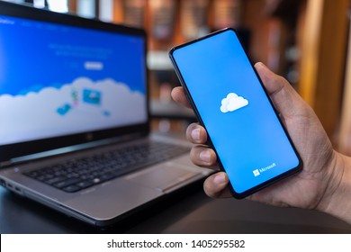 CHIANG MAI, THAILAND - May.01,2019: Man holding Xiaomi Mi Mix 3 with OneDrive on screen. Microsoft OneDrive is a file hosting service that allows users to sync files.