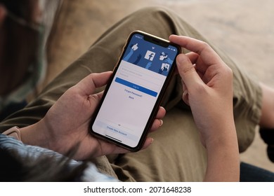 CHIANG MAI, THAILAND - NOV 7, 2021: Facebook social media app logo on log-in, sign-up registration page on mobile app screen on iPhone X in person's hand working on e-commerce shopping business.