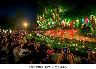 CHIANG MAI, THAILAND - November 23, 2018:Loy Krathong festival.tourist take a photo Buddhist monks sit meditating Under the light of the Beautiful lantern of paper annually at Wat Pan Tao temple
