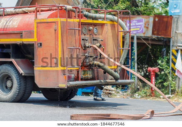 Chiang Mai / Thailand-April14,2020:Municipal\
officials are cleaning roads to clear dirt and oil stains after an\
accident, keeping the road surface full of oil cleaner and\
preventing accidental\
crashes