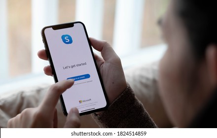 CHIANG MAI,THAILAND - APR 06, 2020 : Woman holding iphone Xs with Skype application, Skype is part of Microsoft, can make video, audio calls, chat messages and do much more using Skype.