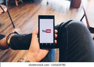 CHIANG MAI,THAILAND - July 07, 2018: A Woman Showing Screen Shot Of Youtube On Sony Mobile Phone YouTube App On The Screen Lying On Old Wood Desk. YouTube Is The Popular Online Video Sharing Website.